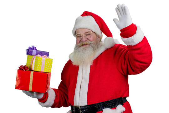 Portrait of happy Santa Claus with gifts. Cheerful Santa Claus waving with hand, isolated on white background.