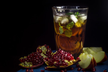 Original rum cocktail serving. Pomegranate on a black background