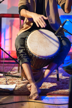 Musician playing djembe drum