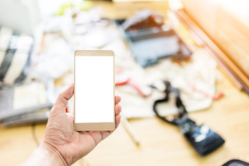 hand with smartphone and blur image background of interior site construction