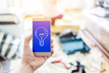 hand with smartphone and blur image background of interior site construction