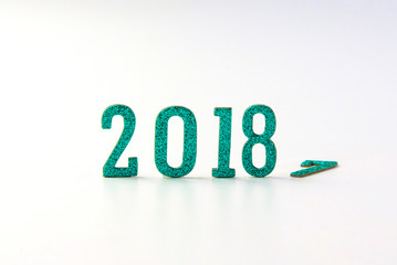 2018 New year concept. Group of businessman and business woman miniature figures sitting on 2 0 1 8 number wooden block toy on world map.