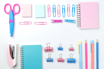 Stationary concept, Flat Lay top view Photo of school supplies scissors, pencils, paper clips,calculator,sticky note,stapler and notepad in pastel tone on white background with copy space, flat lay 