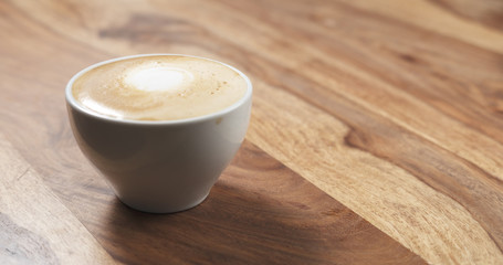 steamed milk poured into coffee cup to make cappuccino
