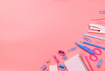 Stationary concept, Flat Lay top view Photo of school supplies scissors, pencils, paper clips,calculator,sticky note,stapler and notepad in pastel tone on pink background with copy space, flat lay