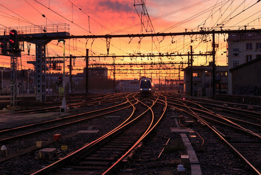 Fototapeta A train on the railroad tracks  during sunrise. Gare de Lyon-Perrache, Lyon, France.