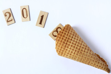 wish abundance 2018/ wooden numbers drop out their waffle horn on a light surface top view