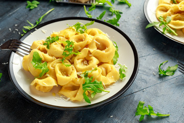 Ravioli with Parmesan and wild rocket on plate