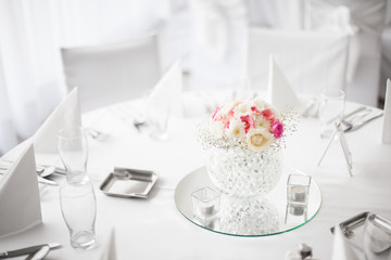 Beautiful centerpiece flower decoration on dining table