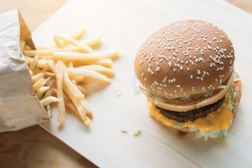 Hamburger on wooden floor And French fries