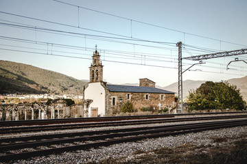 Fototapeta na wymiar Church next to the railway