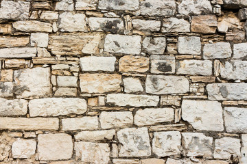 white stones in a very regular wall