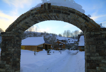 Winter camp site through an arch