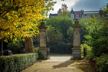 old Entrance to the park with an iron gate and a fence