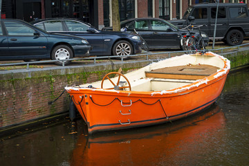 Fototapeta na wymiar wooden boat in Amsterdam canal, October 12, 2017