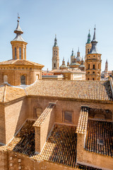 Top view on the roofs and spires of the churches in the center of Zaragoza city during the sunny day in Spain