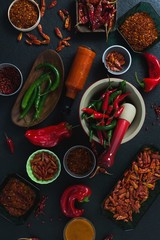 Various spices arranged on black background