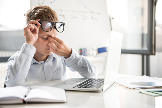 Fatigued Child Is Working In Office