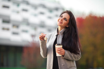 Business, real estate, banking and people concept - smiling business woman with keys over office room or new apartment background