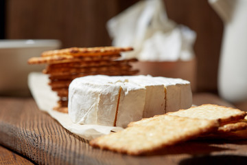 Cheese, vegetables, fruits and spices. Bread, olives and crackers. Mediterranean diet and cuisine. Dark background.