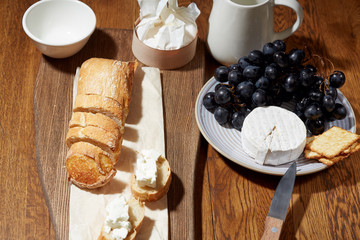 Cheese, vegetables, fruits and spices. Bread, olives and crackers. Mediterranean diet and cuisine. Dark background. Top view.