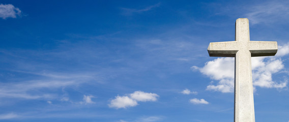 Steinkreuz vor blauem Himmel Panorama