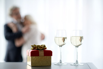Affectionate senior man and woman celebrating special occasion