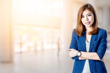 beautiful asian business woman with blur image background of hall in shopping mall with people