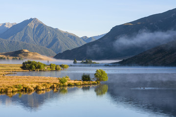  Lake Grasmere, Canterbury, New Zealand, in early morning light, with the Southern Alps as a backdrop.