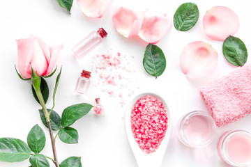 Natural organic cosmetics with rose oil. Cream, lotion, spa salt on white background top view