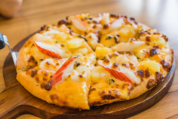 Tropical Seafood Pizza on wooden background