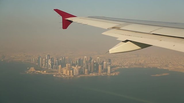 View from the window of the plane to the center of Doha. Skyscrapers of Qatar.