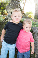 two young boy children pose together to make a family photo