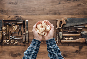 Carpenter holding wood shavings