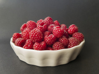 Fresh raspberries in a white bowl