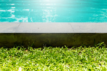 EDGE POOL DESIGN SWIMMING POOL WITH WHITE BORDER WITH TREE BACKGROUND