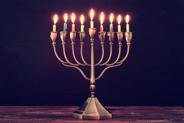 jewish holiday Hanukkah background with menorah (traditional candelabra) and burning candles