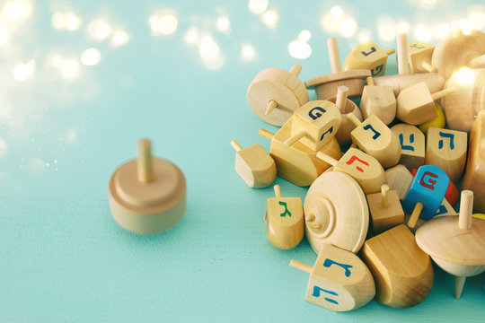 Image of jewish holiday Hanukkah with wooden dreidels colection (spinning top) on the table