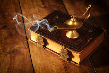 Image of magical aladdin lamp with smoke. Lamp of wishes.