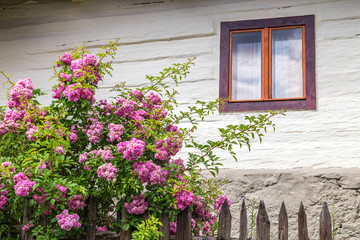 Fototapeta na wymiar An ancient window on the wooden facade of the house, Vlkolinec village, Slovakia, Europe.