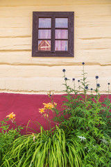 Fototapeta na wymiar An ancient window on the wooden facade of the house, Vlkolinec village, Slovakia, Europe.