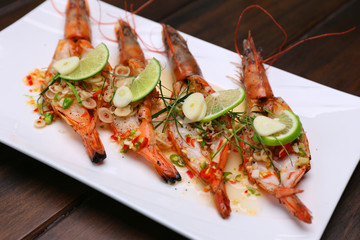 Grilled Spicy River Prawn with lime garlic and lemongrass on wooden table