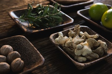 Dried ginger, nutmeg and rosemary herb in a bowl