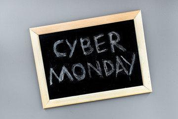 Words cyber monday written on blackboard on grey background top view