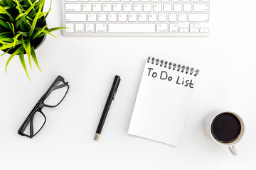To do list for businessman in notebook on office table. White background top view
