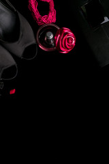 Fashion Lady Accessories Set. Black and pink. Minimal. Shoes, bracelet, perfume, lipstick and bag on black background. Flat lay.