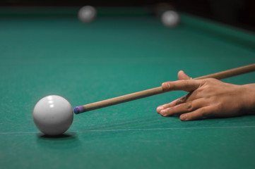 billiard green table in hall with white balls with man hand