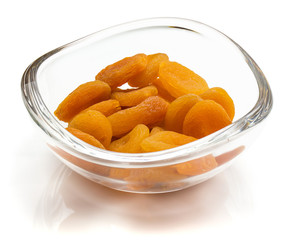 Dried apricots in crystal bowl isolated on white background
