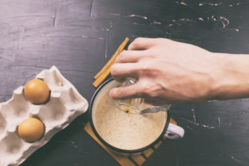 A man prepares eggnog