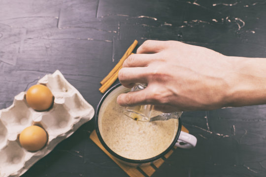 A man prepares eggnog